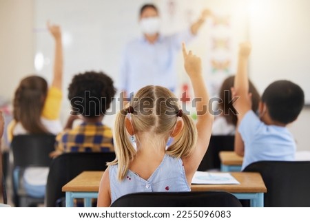 School students raising hands to volunteer, participate and answer during lesson while learning in a classroom. Teacher asking questions to eager, smart and clever young kids questions for education