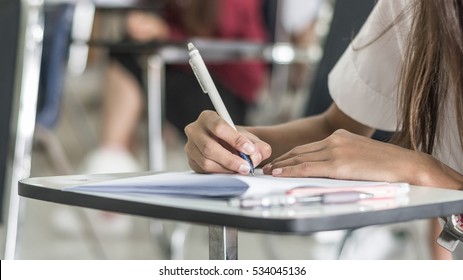 School Student's Taking Exam Writing Answer In Classroom For Education Test And Literacy Concept 