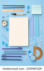 School Supplies Accessories Stationery On Blue Background, Flat Lay, Top View. Education Stationary Stuff Open Notebook, Pens, Pencils And Clock. Back To School Concept. Geometric Flatlay From Above.