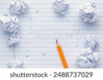 School supplies of blank lined notebook paper with eraser marks and erased pencil writing, surrounded by balled up paper and a sharp pencil. Studying or writing mistakes concept.