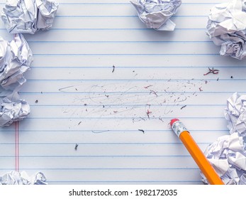 School supplies of blank lined notebook paper with eraser marks and erased pencil writing, surrounded by balled up paper and a pencil eraser. Studying or writing mistakes concept. - Powered by Shutterstock