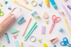 School Supplies Concept. Top View Photo Of Scattered Stationery Correction Pens Pink Pencil-case Staplers Binder Clips Adhesive Tape Scissors Sharpeners And Erasers On Isolated White Background