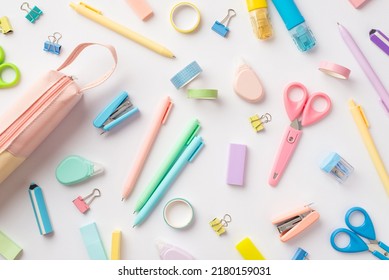 School supplies concept. Top view photo of scattered stationery correction pens pink pencil-case staplers binder clips adhesive tape scissors sharpeners and erasers on isolated white background - Powered by Shutterstock