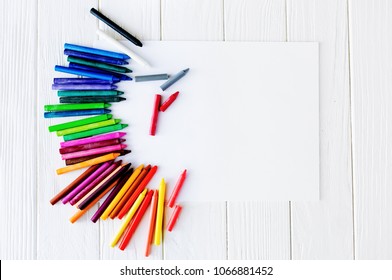 School Supplies For Drawing On The Table: Paper And Crayons