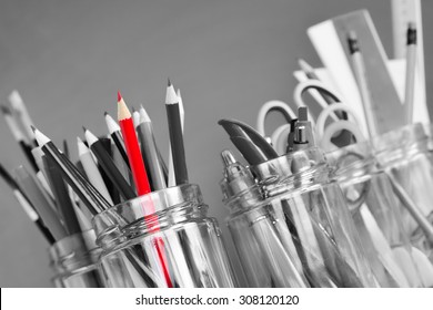 School supplies in jars against the blackboard - Powered by Shutterstock