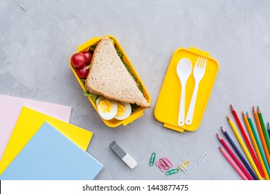 School Supplies And Lunch Box With Sandwich And Vegetables. Back To School. Healthy Eating Habits Concept - Background Layout With Free Text Space. Flat Lay Composition, Mockup, Top View