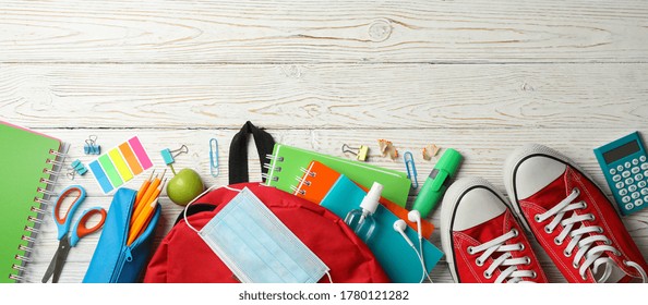 School Supplies With Medical Mask And Sanitizer On Wooden Background