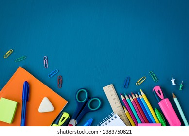 School supplies on blue background. Top view. Copy space.