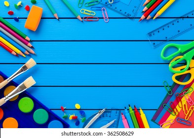 School Supplies On Blue Wooden Table