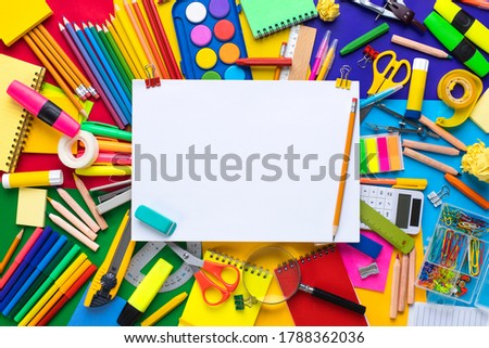 School supplies on colored background with blank paper. Back to school concept