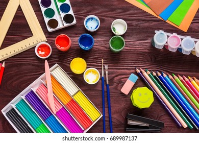 School supplies on a red background, paints and brushes - Powered by Shutterstock