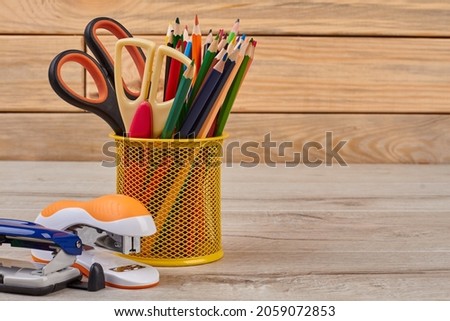 School supplies on wooden background.