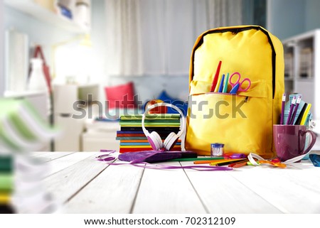 School supplies on a wooden table in a warm interior