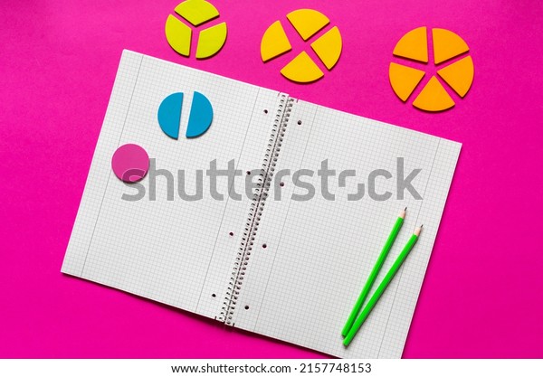 School supplies, open notepad, rulers,\
fractions on a magenta pink background. Interesting, fun math for\
kids. Education, back to school\
concept