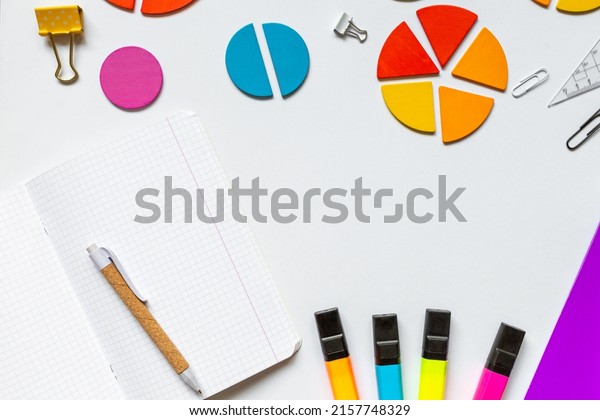 School supplies, open notepad, rulers, fractions\
on a white background. Interesting, fun math for kids. Education,\
back to school concept