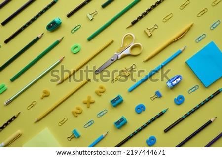 School supplies products accessories diagonal pattern isolated on yellow minimalist monochromatic background, trendy flatlay, top view. Stationery stuff equipment for education. Back to school concept