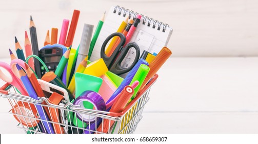 School Supplies In A Shopping Basket On White Background