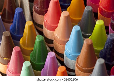 School supplies showing Crayons of many different colors lined up in the box