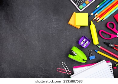 School supplies side border. Top down view on a dark blackboard background. Copy space. Back to school concept. - Powered by Shutterstock