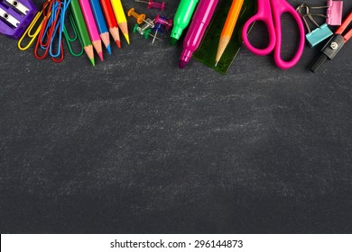 School supplies top border on a chalkboard background