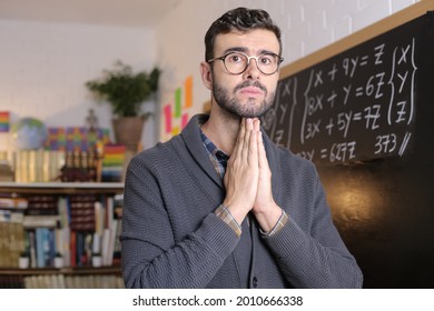 School Teacher Praying In Classroom