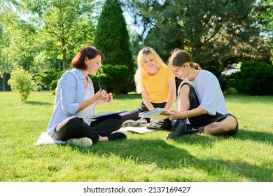 School Teacher, Psychologist, Social Worker Talking To Teenagers, Sitting On Grass