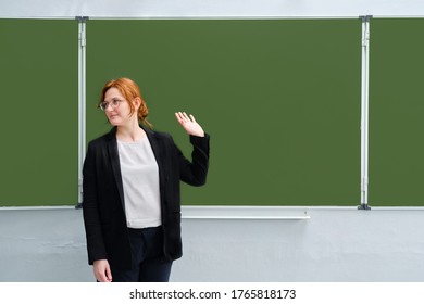 School Teacher Waves His Hand Against The Blackboard, Copy Space. The Concept Of Leaving School, Completing Lessons, Or Being Fired