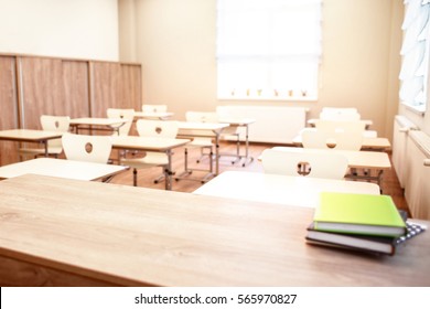 School Teacher's Desk With Stack Of Books