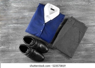School uniform on wooden background - Shutterstock ID 523573819