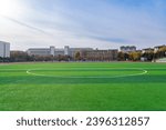 In the school yard:a football field and school building.