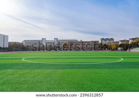 In the school yard:a football field and school building.