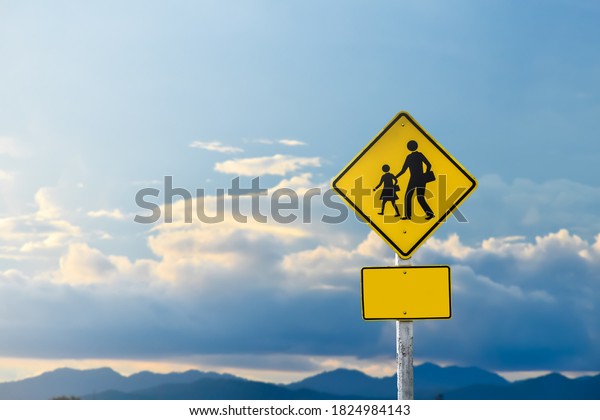 School zone ahead sign isolated on clouds on\
the sky background.