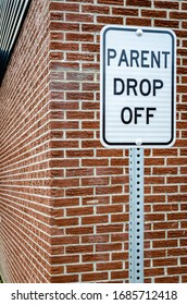 School Zone Parent Drop Off Sign Next To A Brown Brick Exterior Wall