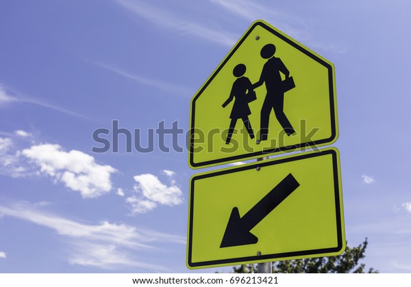 school zone sign in\
front of a blue sky