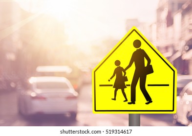 School Zone Warning Sign On Blur Traffic Road With Colorful Bokeh Light Abstract Background. Copy Space Of Transportation And Travel Concept. Vintage Tone Filter Color Style.