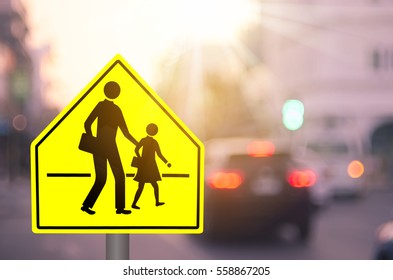 School Zone Warning Sign On Blur Traffic Road With Colorful Bokeh Light Abstract Background. Copy Space Of Transportation And Travel Concept. Vintage Tone Filter Color Style.