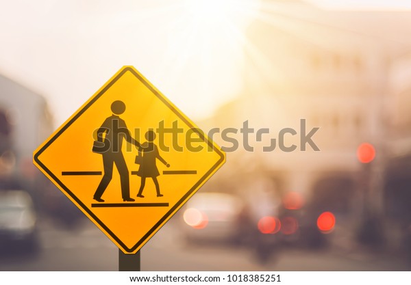 School\
zone warning sign on blur traffic road with colorful bokeh light\
abstract background. Copy space of transportation and travel\
concept. Vintage tone filter effect color\
style.