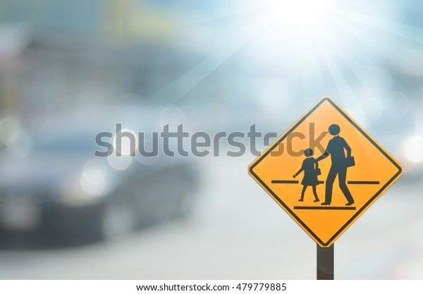 School zone warning\
sign on blur traffic road with colorful bokeh light abstract\
background. Copy space of transportation and travel concept.\
Vintage tone color\
style.