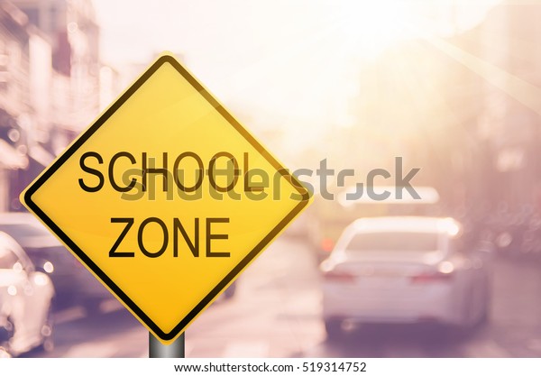 School zone
warning sign on blur traffic road with colorful bokeh light
abstract background. Copy space of transportation and travel
concept. Vintage tone filter color
style.