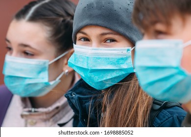 School-age Children In Medical Masks. Portrait Of School Children