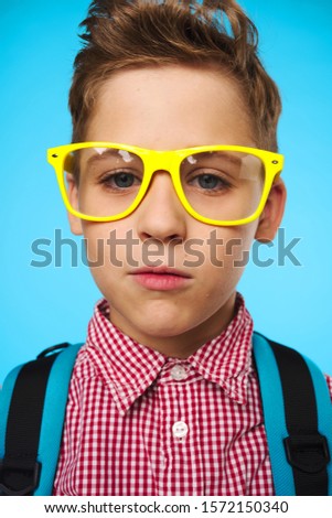 Schoolboy with backpack glasses childhood education