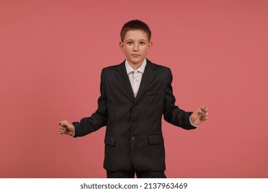 A Schoolboy In A Black Suit With Painted Nails Stands On A Pink Background