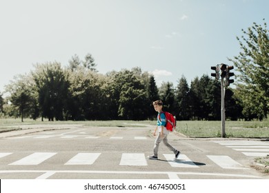 Schoolboy crossing road on way to school