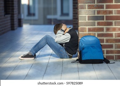 schoolboy crying in the hallway of the school, negative emotion - Powered by Shutterstock