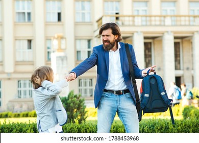 Schoolboy Does Not Want To Go To School. Father Taking Son To School. Dad Hurries, Is Late To School And Work. Child Has Tantrum Before Lessons. Parents, Relationship With Children And Family Problem.