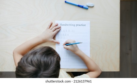 A Schoolboy Doing Math Lesson Sitting At Desk In The Children Room,top View, Close Up