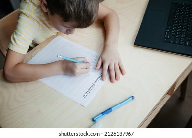 A Schoolboy Doing Math Lesson Sitting At Desk In The Children Room,top View, Close Up