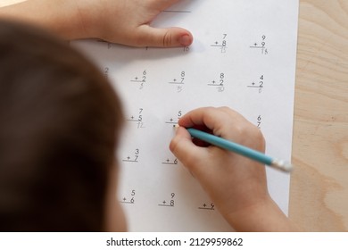 A Schoolboy Doing Math Lesson Sitting At Desk In The Children Room,top View, Close Up