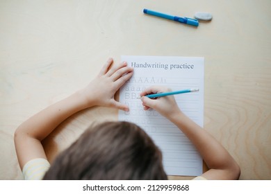 A Schoolboy Doing Math Lesson Sitting At Desk In The Children Room,top View, Close Up