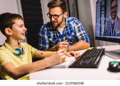 Schoolboy Educate Online. Father Helps His Son With Home Work. Boy In Video Conference With Teacher On Computer At Home.